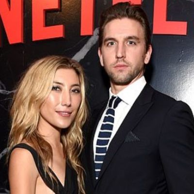 Dichen Lachman posing with er husband by wearing a black dress.